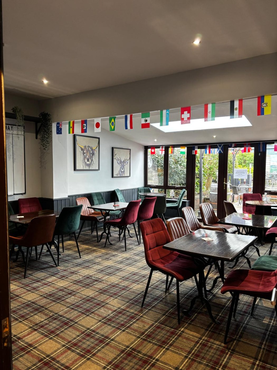 The function room, set with tables and chairs, opening onto the beer garden